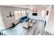 Bright living room featuring modern gray floors, ample windows, and comfortable blue sofa at 15920 Hayloft Ln, Parker, CO 80134