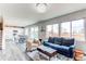 Open-concept living room flowing into a modern kitchen with white cabinets at 15920 Hayloft Ln, Parker, CO 80134
