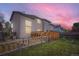 Backyard with wooden deck, grass area, and fencing around the property at 401 W 114Th Pl, Northglenn, CO 80234