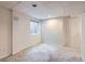 Finished basement area with neutral carpet, window, and access door at 401 W 114Th Pl, Northglenn, CO 80234