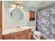 Bathroom featuring a round mirror, neutral walls, standard fixtures, and a shower with floral curtain at 401 W 114Th Pl, Northglenn, CO 80234