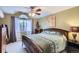 Cozy bedroom with a ceiling fan, large window, and neutral carpet, creating a serene retreat at 401 W 114Th Pl, Northglenn, CO 80234