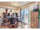 The dining area has hardwood floors, slider door access to the deck, and lovely wood cabinets at 401 W 114Th Pl, Northglenn, CO 80234