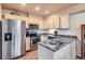 Well-lit kitchen featuring stainless steel appliances, light-colored cabinets, and modern fixtures at 401 W 114Th Pl, Northglenn, CO 80234