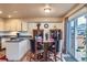 A bright dining area off the kitchen features a wood floor and a sliding glass door to the outside deck at 401 W 114Th Pl, Northglenn, CO 80234