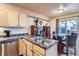 Bright kitchen features stainless steel appliances, double sink, and adjacent dining area with sliding door access at 401 W 114Th Pl, Northglenn, CO 80234