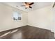 Bright bedroom with dark hardwood floors and ceiling fan at 5946 S Kellerman Ct, Aurora, CO 80016