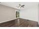 Bright bedroom with hardwood floors, decorative wall paneling, and a sliding glass door to the outdoors at 1607 Cottonwood Dr # 14, Louisville, CO 80027