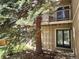 Inviting condo with a private balcony and a cozy entrance, surrounded by mature trees and natural landscaping at 1607 Cottonwood Dr # 14, Louisville, CO 80027