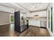 Modern kitchen boasts stainless steel appliances, white cabinetry, and granite countertops with hardwood floors at 1607 Cottonwood Dr # 14, Louisville, CO 80027
