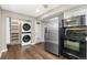 Efficient kitchen design featuring stainless steel appliances, sleek cabinetry, and convenient in-unit laundry access at 1607 Cottonwood Dr # 14, Louisville, CO 80027