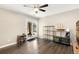 Bright living room featuring wood floors, a ceiling fan, and access to the outdoors through sliding glass doors at 1607 Cottonwood Dr # 14, Louisville, CO 80027