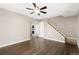 Open-concept living room featuring sleek hardwood floors, a modern ceiling fan, and convenient in-unit laundry at 1607 Cottonwood Dr # 14, Louisville, CO 80027