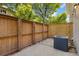 Fenced patio with concrete and brick pavers, framed by lush trees and vegetation at 1607 Cottonwood Dr # 14, Louisville, CO 80027