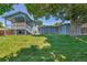 Large backyard featuring a covered deck and mature trees at 8160 W 81St Pl, Arvada, CO 80005