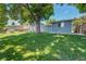 Lush backyard with mature trees, deck, and additional shed at 8160 W 81St Pl, Arvada, CO 80005
