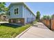 A charming, blue two-story home with a gated driveway at 8160 W 81St Pl, Arvada, CO 80005