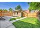 Backyard with a pergola, brick patio, and lush green lawn at 1343 Milwaukee St, Denver, CO 80206