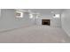 Finished basement with neutral carpet, light walls, and a charming brick fireplace at 1343 Milwaukee St, Denver, CO 80206
