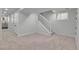 Finished basement area with a staircase, neutral carpet, and white painted walls and trim at 1343 Milwaukee St, Denver, CO 80206