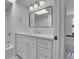 Bathroom featuring subway tile walls, a rain shower head, and a modern white vanity at 1343 Milwaukee St, Denver, CO 80206