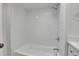 Bathroom with tiled shower and tub with sleek hardware, bright white subway tile at 1343 Milwaukee St, Denver, CO 80206