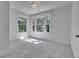 Carpeted bedroom with lots of natural light from dual windows with bright white trim and neutral paint at 1343 Milwaukee St, Denver, CO 80206