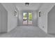 Bright bedroom featuring gray carpet, white walls, and French doors leading to a balcony at 1343 Milwaukee St, Denver, CO 80206