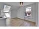 Bonus room with skylight and window, natural wood floors and white walls at 1343 Milwaukee St, Denver, CO 80206