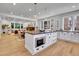 Open kitchen with large island perfect for entertaining, with stainless steel appliances, dining, and living room visible at 1343 Milwaukee St, Denver, CO 80206