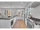 Bright, modern kitchen features stainless steel appliances and a large island with bar seating and plenty of natural light at 1343 Milwaukee St, Denver, CO 80206