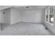 Open living area featuring large windows, and soft carpeting at 1343 Milwaukee St, Denver, CO 80206