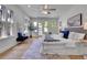 Bright main bedroom boasts hardwood floors, access to a balcony, and an oversized bed at 1343 Milwaukee St, Denver, CO 80206