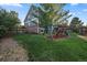 Large backyard with playground set and expansive lawn at 7291 Palisade Dr, Highlands Ranch, CO 80130