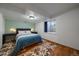 Spacious basement bedroom with wood floors and en suite bathroom at 7291 Palisade Dr, Highlands Ranch, CO 80130