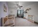 Bedroom with crib and neutral color palette at 7291 Palisade Dr, Highlands Ranch, CO 80130