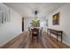 Dining room with hardwood floors, large windows, and a wooden dining table at 7291 Palisade Dr, Highlands Ranch, CO 80130