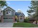 Two-story house with gray siding, brick accents, and a two-car garage at 7291 Palisade Dr, Highlands Ranch, CO 80130