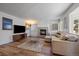 Living area with hardwood floors, fireplace, and lots of natural light at 7291 Palisade Dr, Highlands Ranch, CO 80130