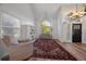 Living room with hardwood floors, vaulted ceiling, and a cozy seating area at 7291 Palisade Dr, Highlands Ranch, CO 80130