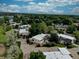 An overhead view displays cozy homes surrounded by greenery and a nearby lake at 1769 S Lee St # B, Lakewood, CO 80232