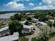 This aerial shot showcases homes near a lake with ample tree coverage at 1769 S Lee St # B, Lakewood, CO 80232