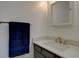 Bathroom vanity with quartz countertops, modern faucet, and towel bar at 1769 S Lee St # B, Lakewood, CO 80232