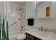 This full bathroom is complete with sleek marble tiling, modern fixtures, and a shower-tub combo at 1769 S Lee St # B, Lakewood, CO 80232