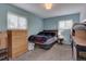 Bedroom with windows, dresser, and furniture, providing a cozy and inviting space at 1769 S Lee St # B, Lakewood, CO 80232