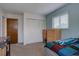 Bedroom showcasing closet, dresser, large window, and ample natural light at 1769 S Lee St # B, Lakewood, CO 80232