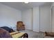 Spare bedroom featuring neutral carpet, a chair, and a window, perfect for guests or a home office at 1769 S Lee St # B, Lakewood, CO 80232