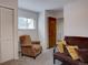 Spare bedroom featuring carpet, a chair, a futon, and a window, perfect for guests or a home office at 1769 S Lee St # B, Lakewood, CO 80232