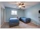 Bright bedroom with two beds, carpeted floor, ceiling fan, and a large window at 1769 S Lee St # B, Lakewood, CO 80232