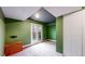Finished basement with patio door, storage closet, and green walls at 7682 S Steele St, Centennial, CO 80122